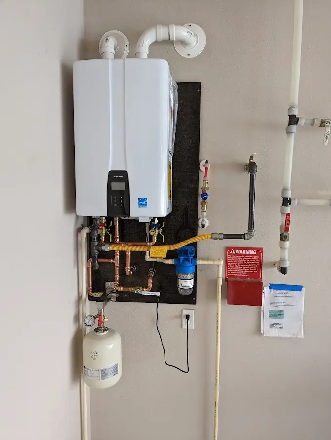 Professional plumber installing copper piping in a Taylor home